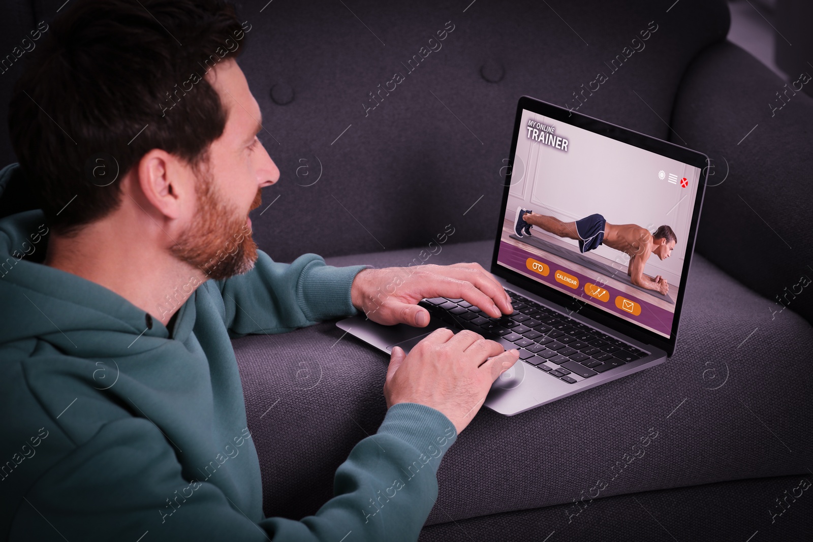 Image of Personal trainer online. Man viewing website via laptop at home