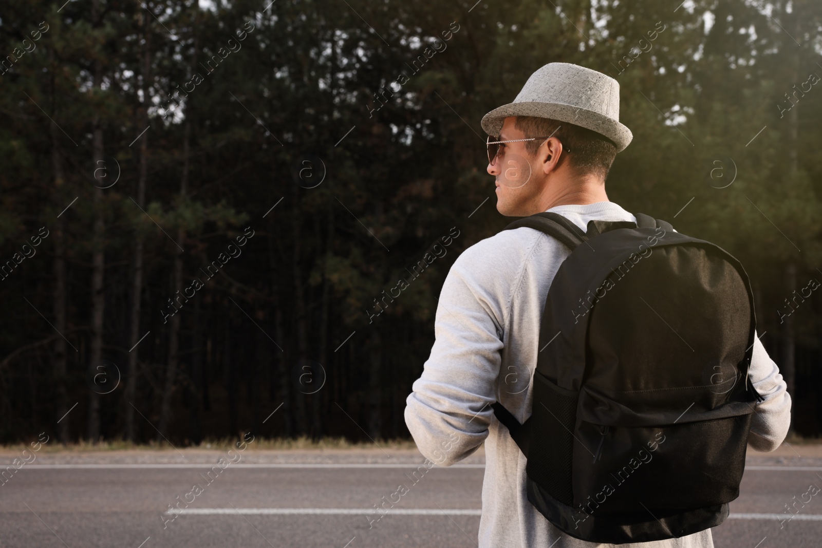 Photo of Man with backpack on road near forest