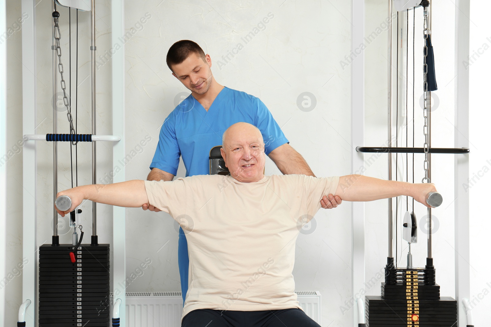 Photo of Patient exercising under physiotherapist supervision in rehabilitation center