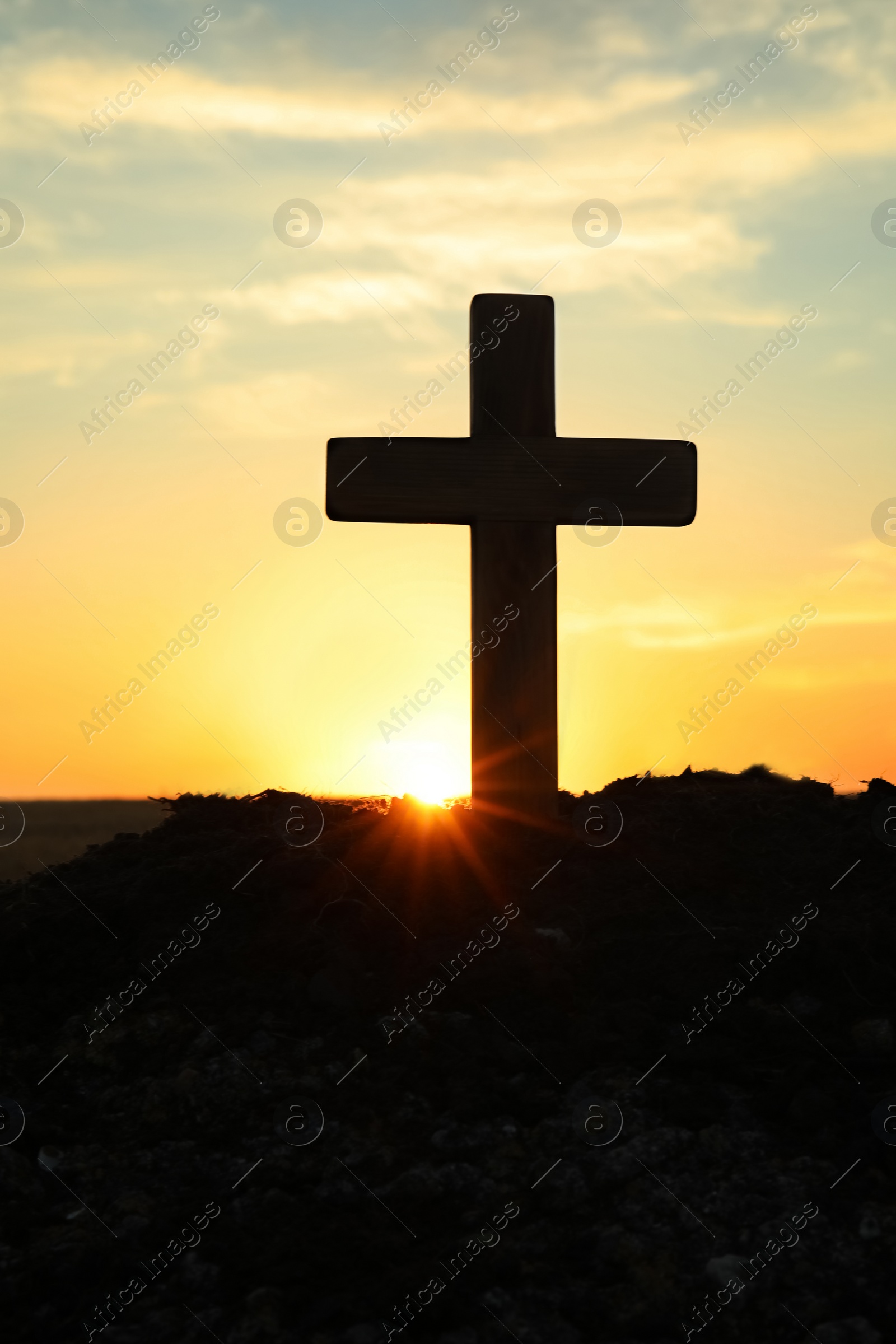 Photo of Silhouette of Christian cross outdoors at sunrise. Religion concept