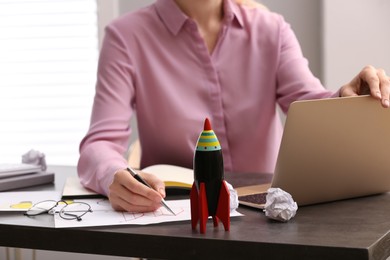 Photo of Woman working at messy table, closeup. Startup concept