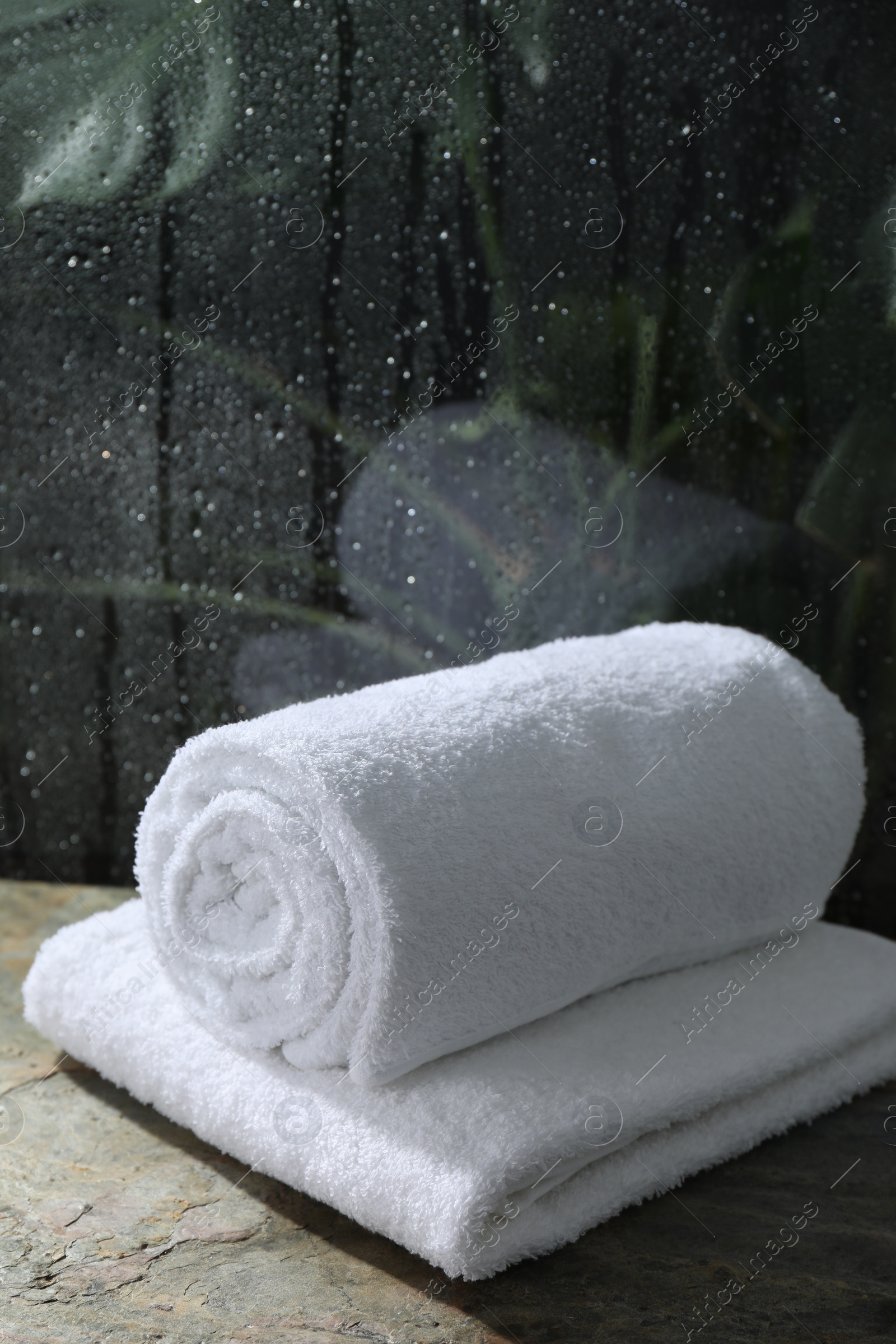 Photo of White terry towels on table in bathroom