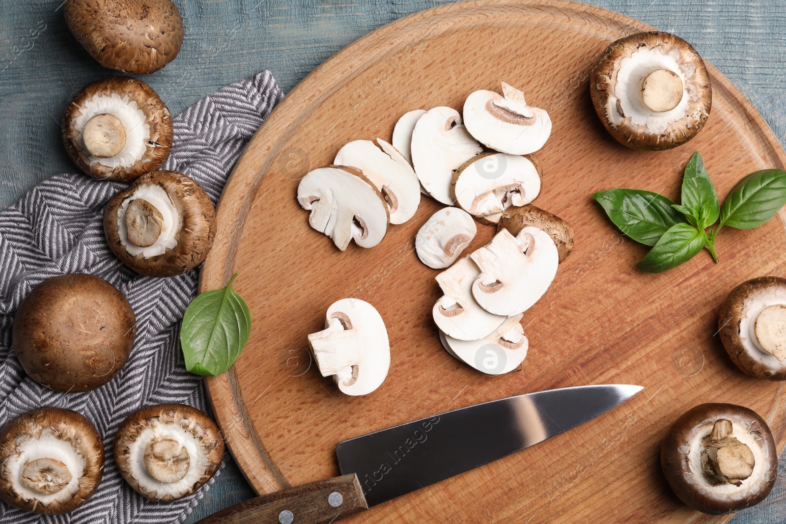 Photo of Flat lay composition with fresh raw mushrooms on wooden table