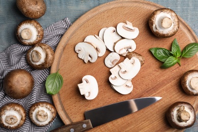 Flat lay composition with fresh raw mushrooms on wooden table