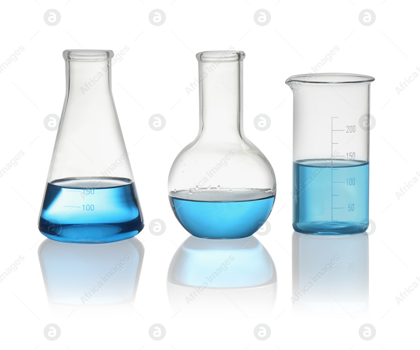 Photo of Different laboratory glassware with light blue liquid isolated on white