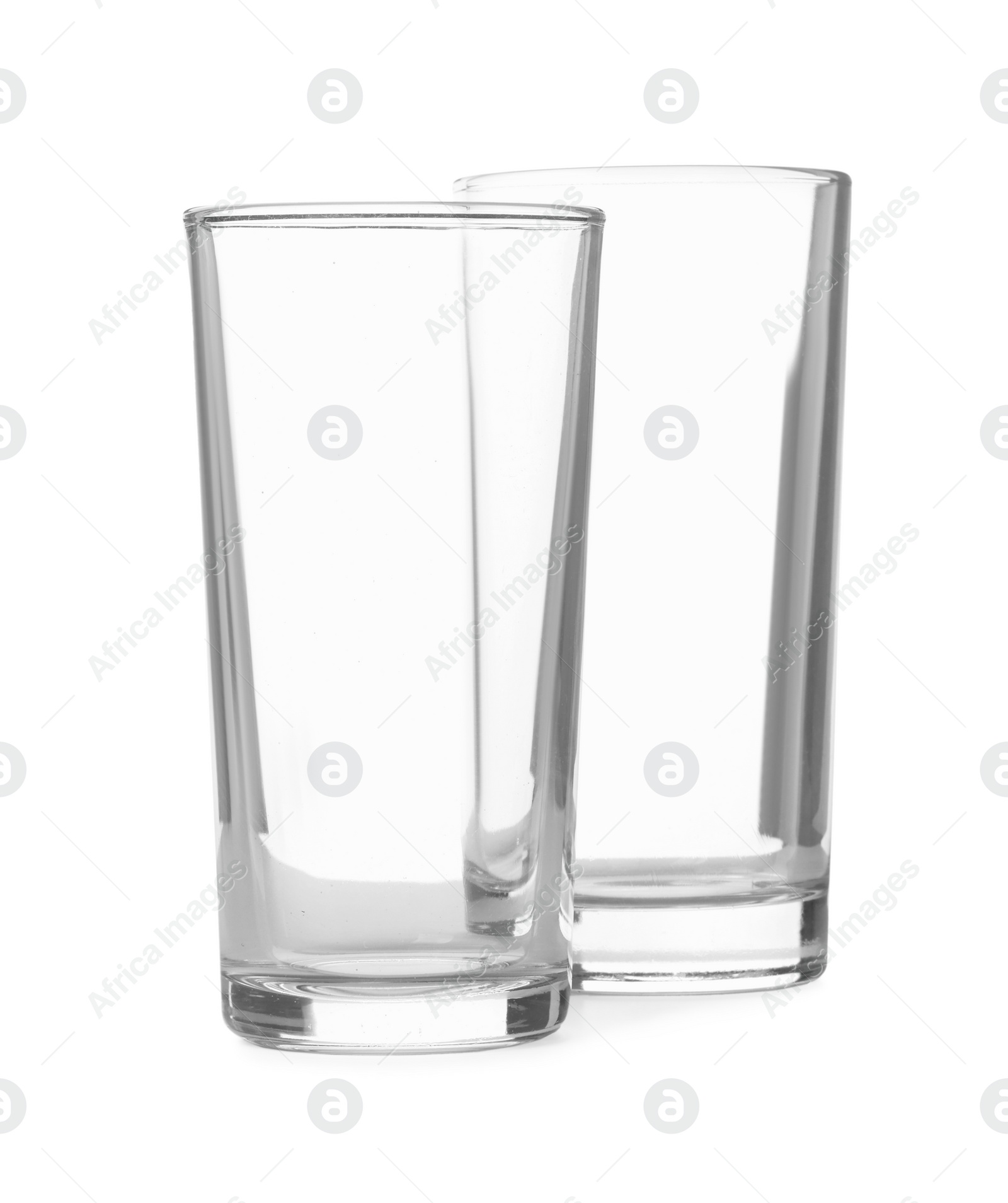 Photo of Two clean empty highball glasses isolated on white