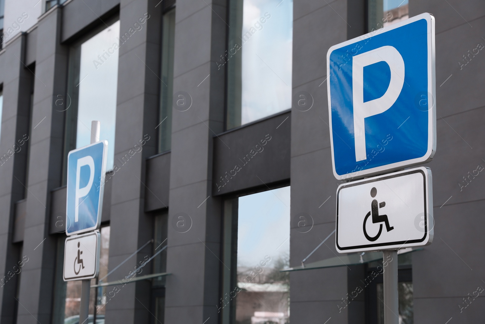 Photo of Traffic sign Parking for people with disability near modern building