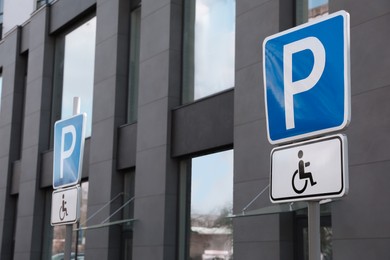 Photo of Traffic sign Parking for people with disability near modern building