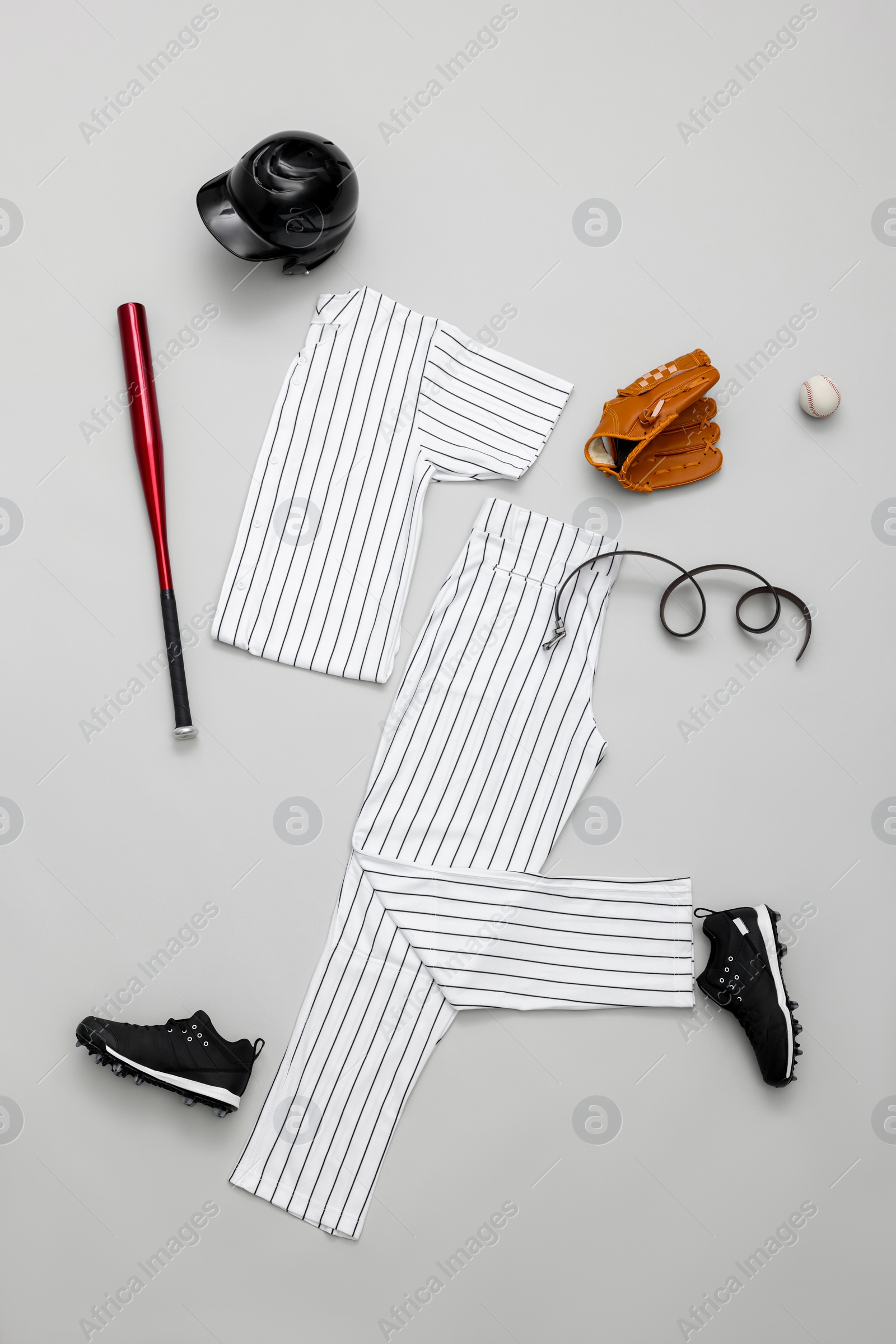 Photo of Flat lay composition with baseball uniform on white background