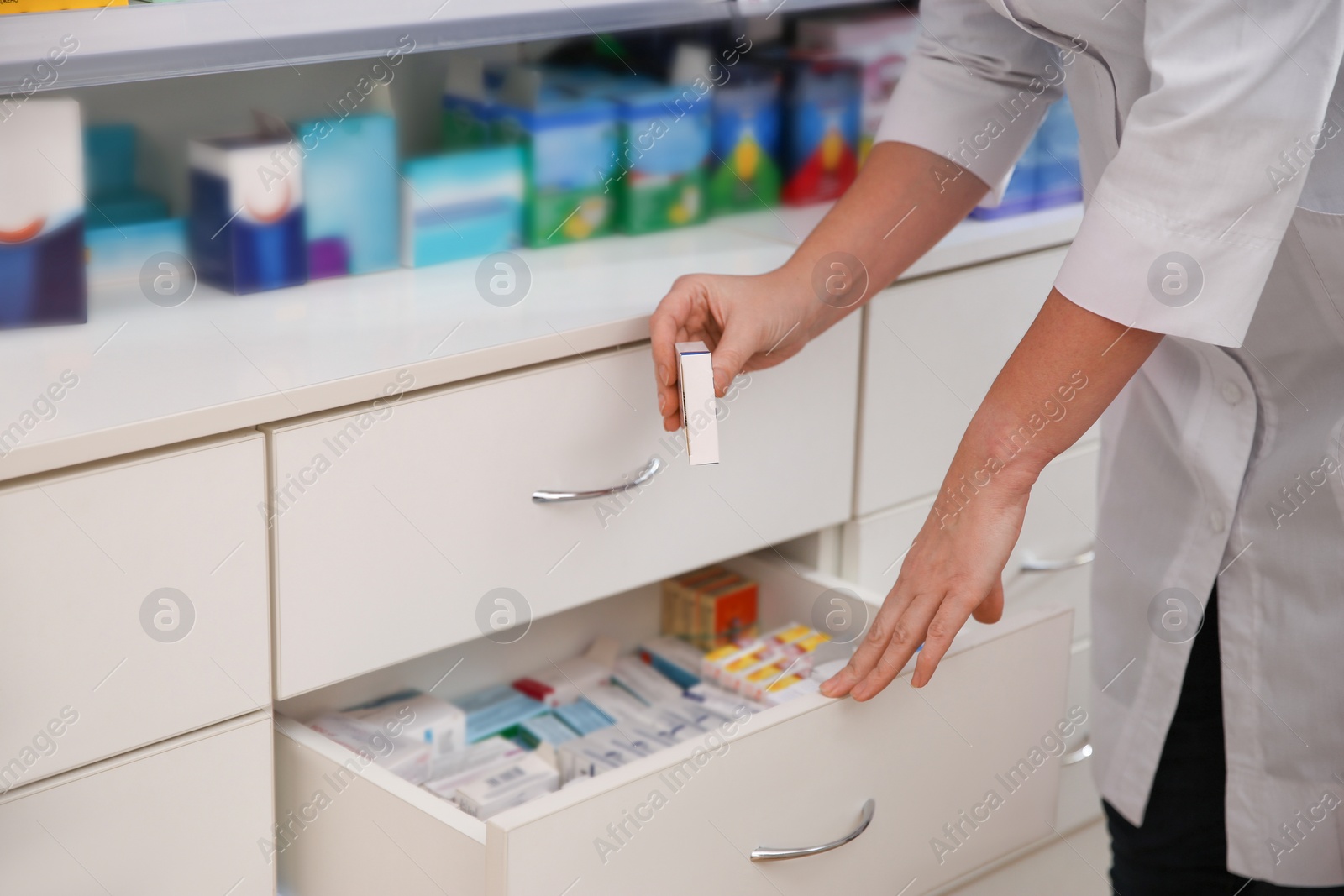 Photo of Professional pharmacist with medicine in drugstore, closeup