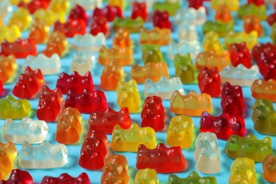 Photo of Flat lay composition with delicious jelly bears on color background