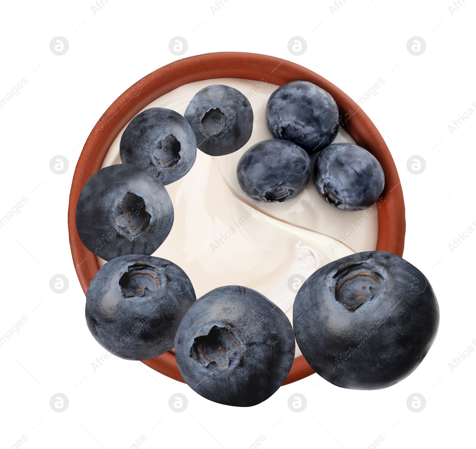 Image of Delicious ripe blueberries falling into bowl with yogurt on white background, top view