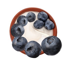 Image of Delicious ripe blueberries falling into bowl with yogurt on white background, top view