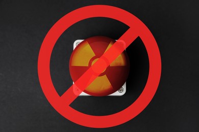 Illustration of Prevent atomic war. Red button of nuclear weapon under prohibition sign on black background, top view