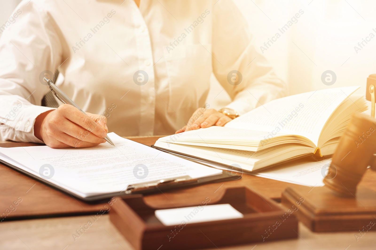 Image of Lawyer working with document at table in office, closeup