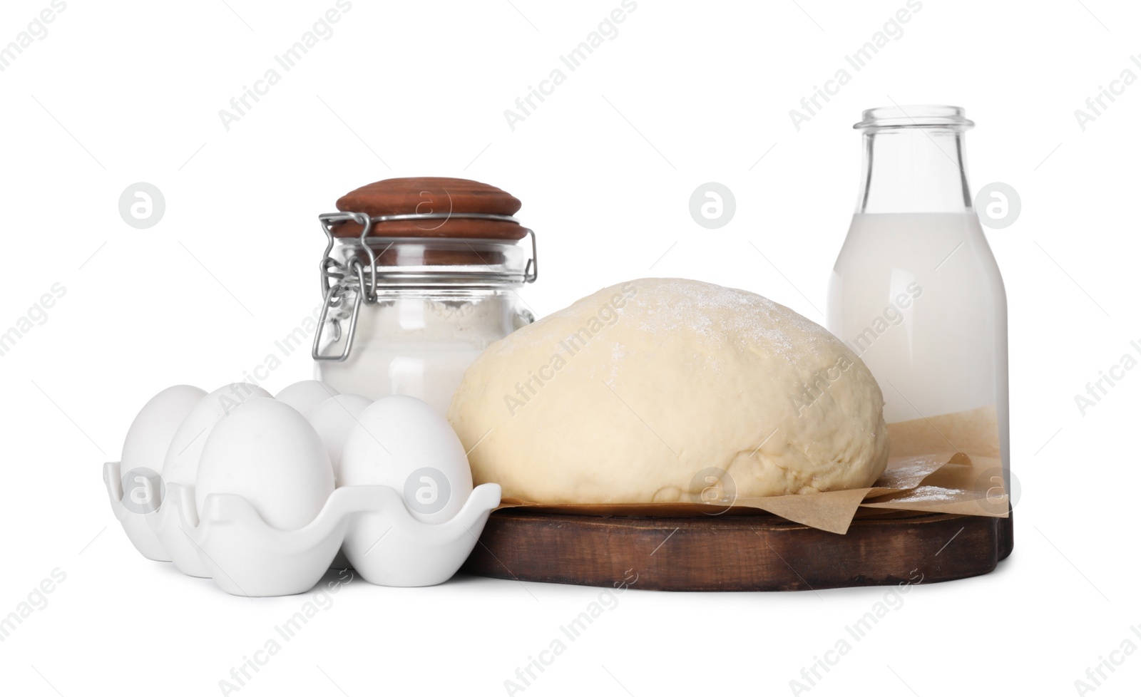 Photo of Natural ingredients and raw dough on white background