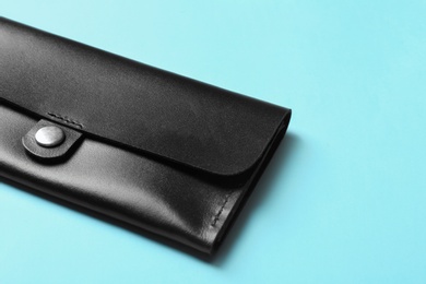 Photo of Leather wallet on color background, closeup with space for text. Stylish accessory