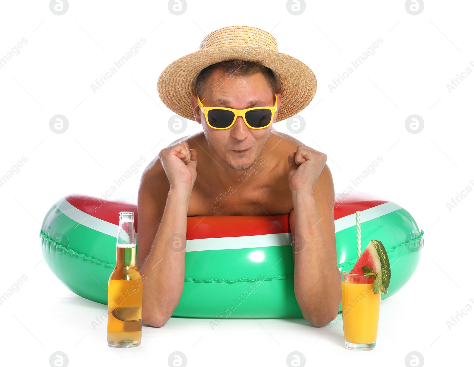 Photo of Shirtless man with inflatable ring,  cocktail and bottle of drink on white background