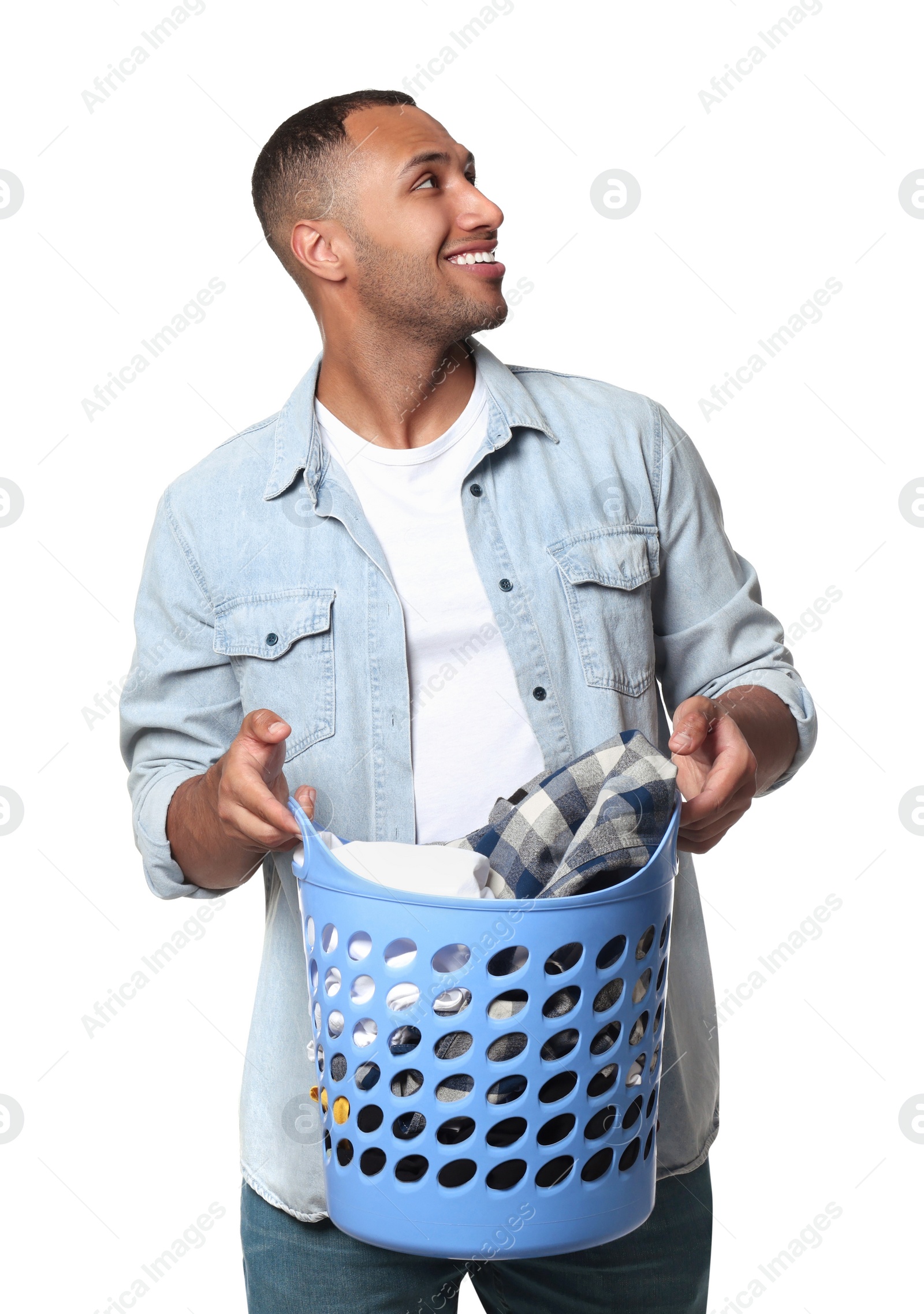 Photo of Happy man with basket full of laundry on white background