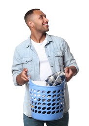 Photo of Happy man with basket full of laundry on white background