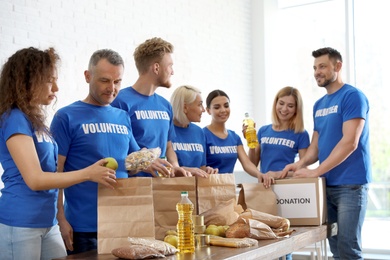 Team of volunteers collecting food donations indoors