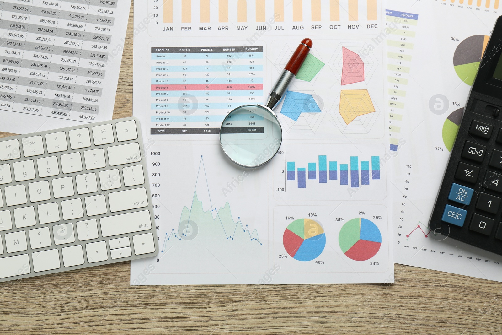 Photo of Accounting documents, magnifying glass, computer keyboard and calculator on wooden table, flat lay