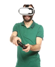 Photo of Emotional young man playing video games with virtual reality headset and controller isolated on white