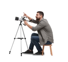 Photo of Excited astronomer with telescope pointing at something on white background