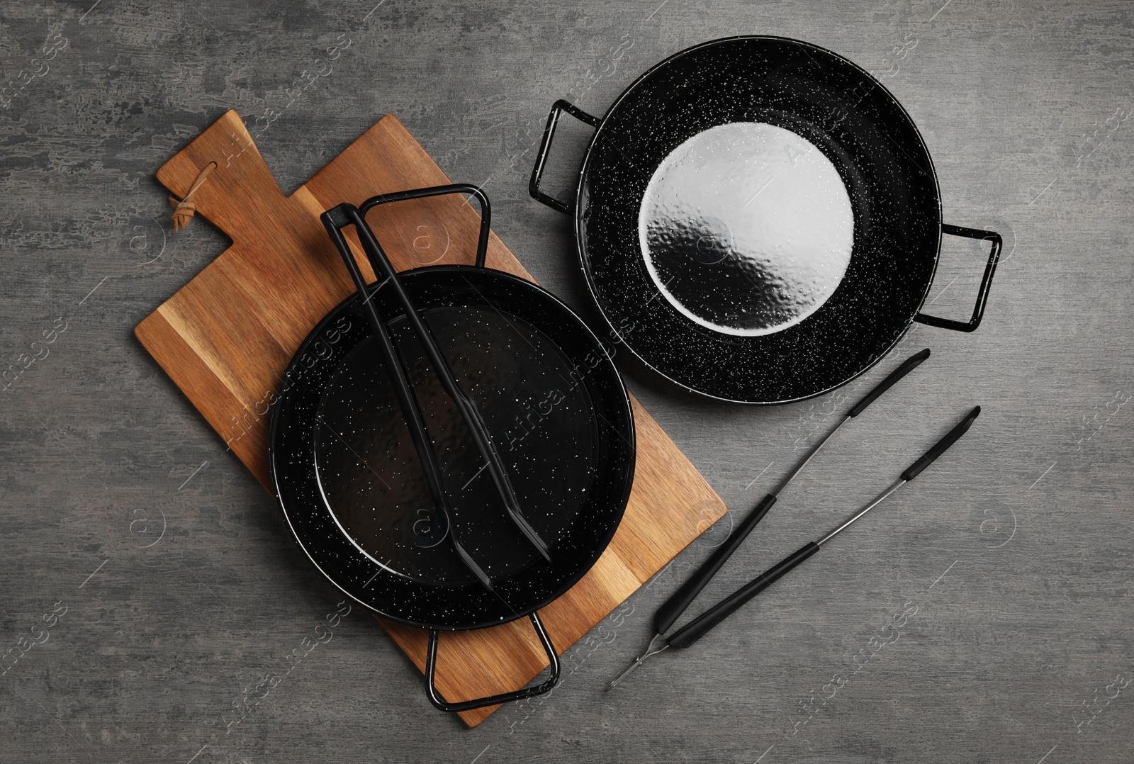 Photo of Set of cooking utensils on grey table, flat lay