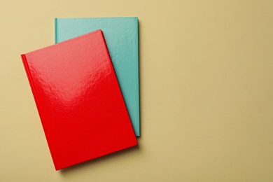 New bright planners on beige background, top view. Space for text