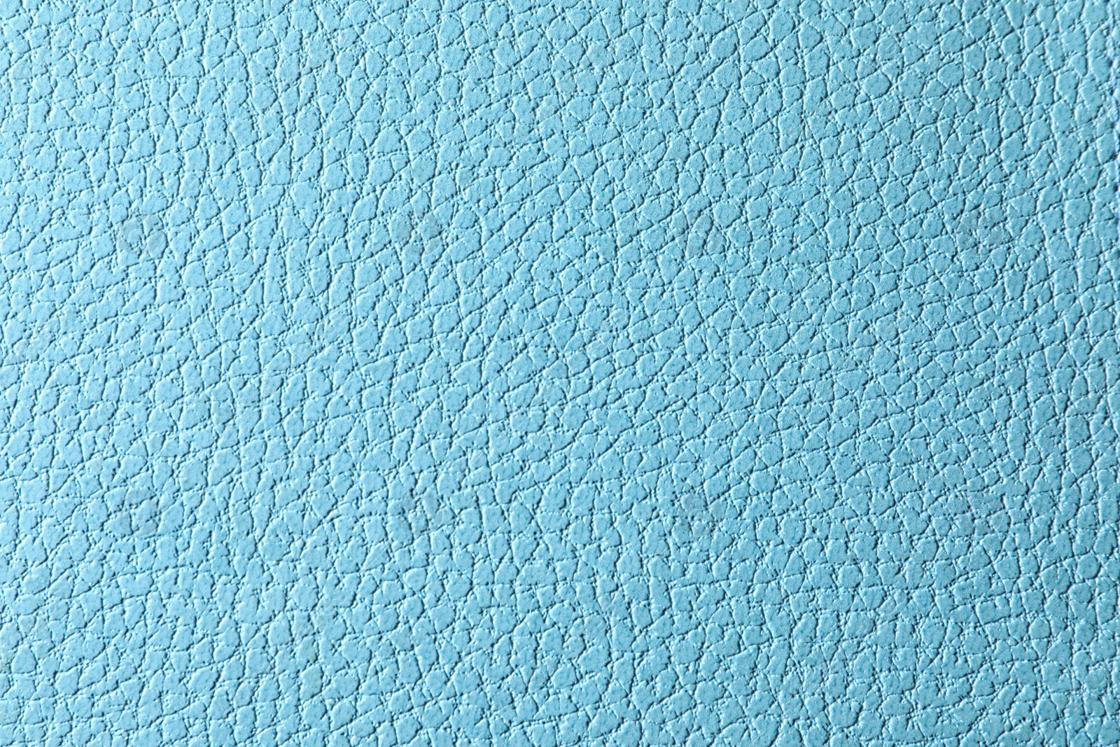 Photo of Texture of light blue leather as background, closeup