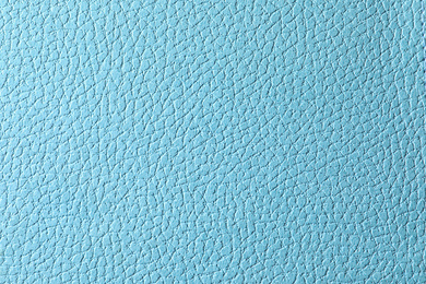 Photo of Texture of light blue leather as background, closeup