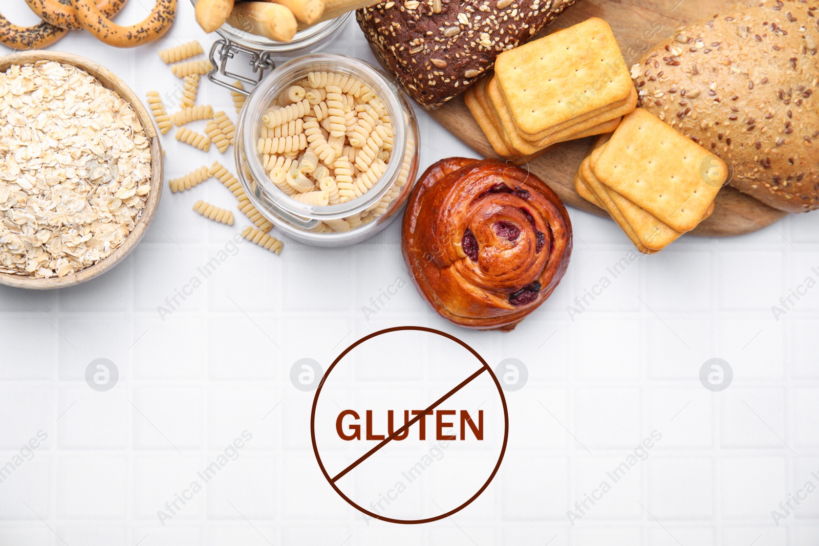 Image of Different gluten free products on white tiled table, flat lay