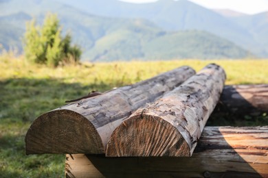 Photo of Stack of cut firewood outdoors, closeup. Heating in winter
