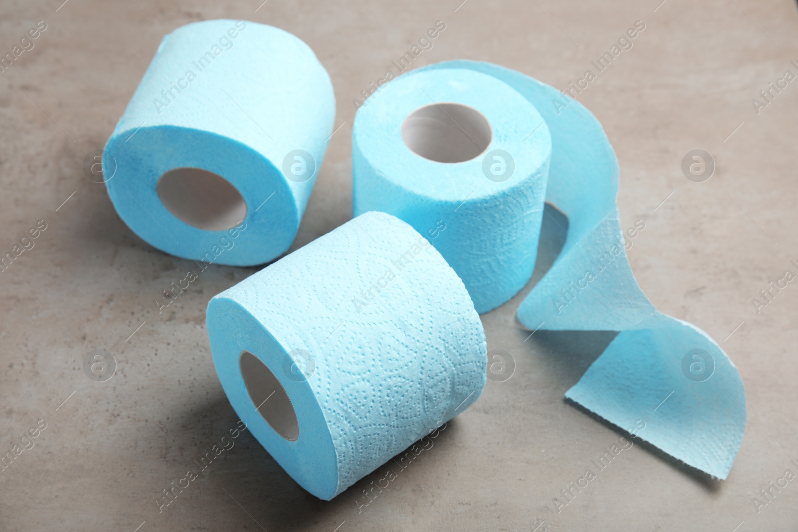 Photo of Toilet paper rolls on grey background. Personal hygiene