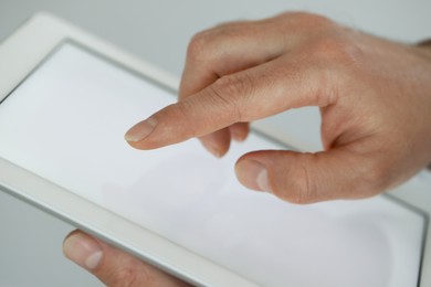 Photo of Closeup view of man using new tablet indoors