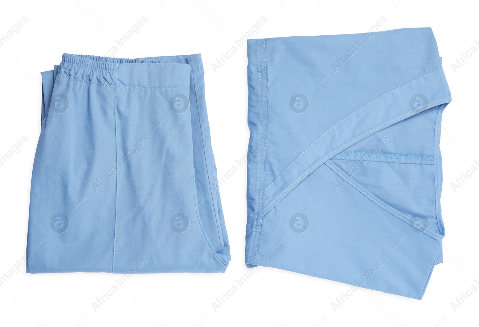 Photo of Light blue medical uniforms isolated on white , top view