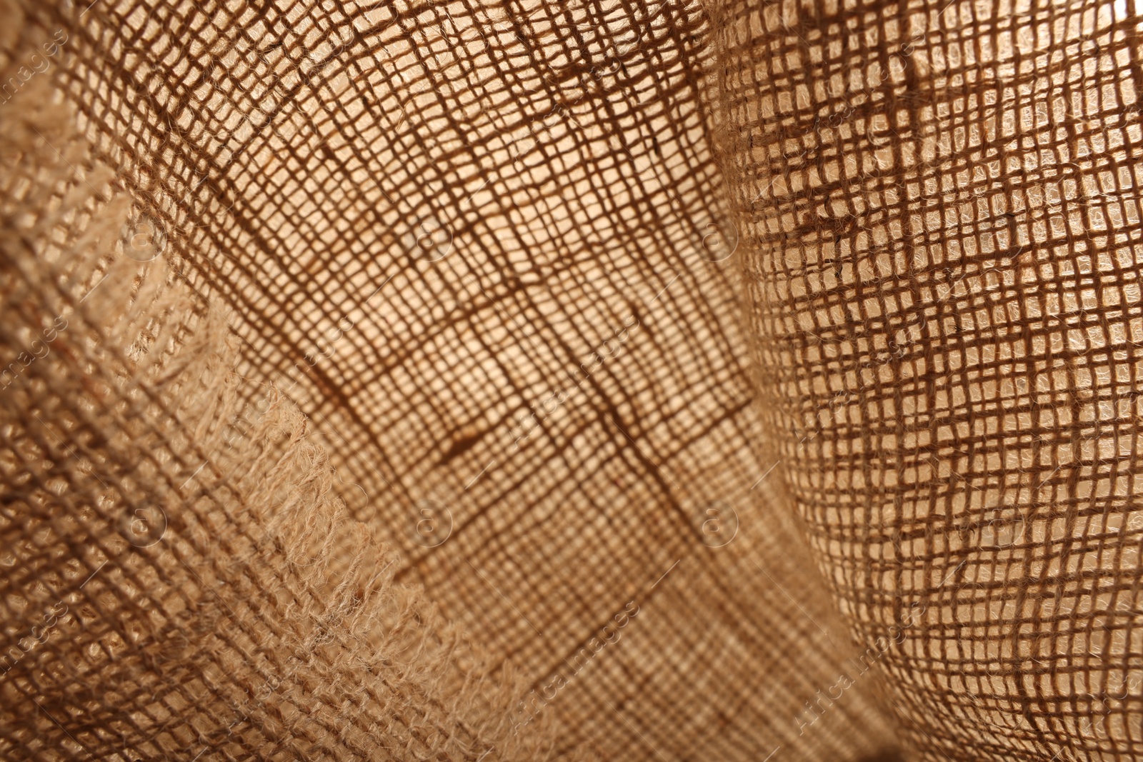 Photo of Texture of natural burlap fabric as background, closeup