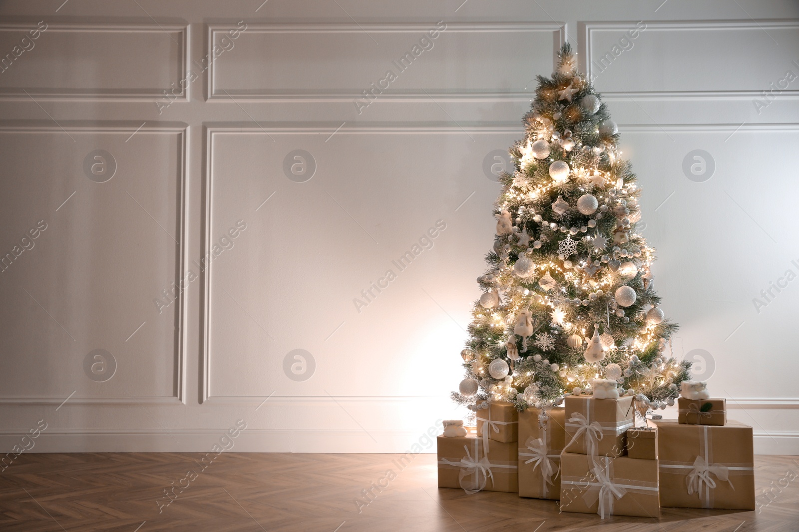 Photo of Beautiful decorated Christmas tree and gifts indoors. Space for text