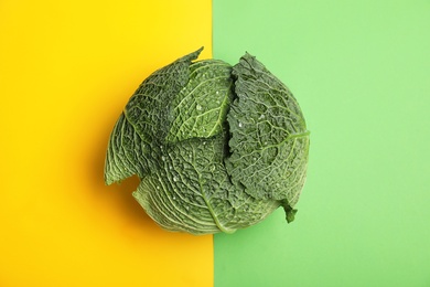 Fresh green savoy cabbage on color background, top view