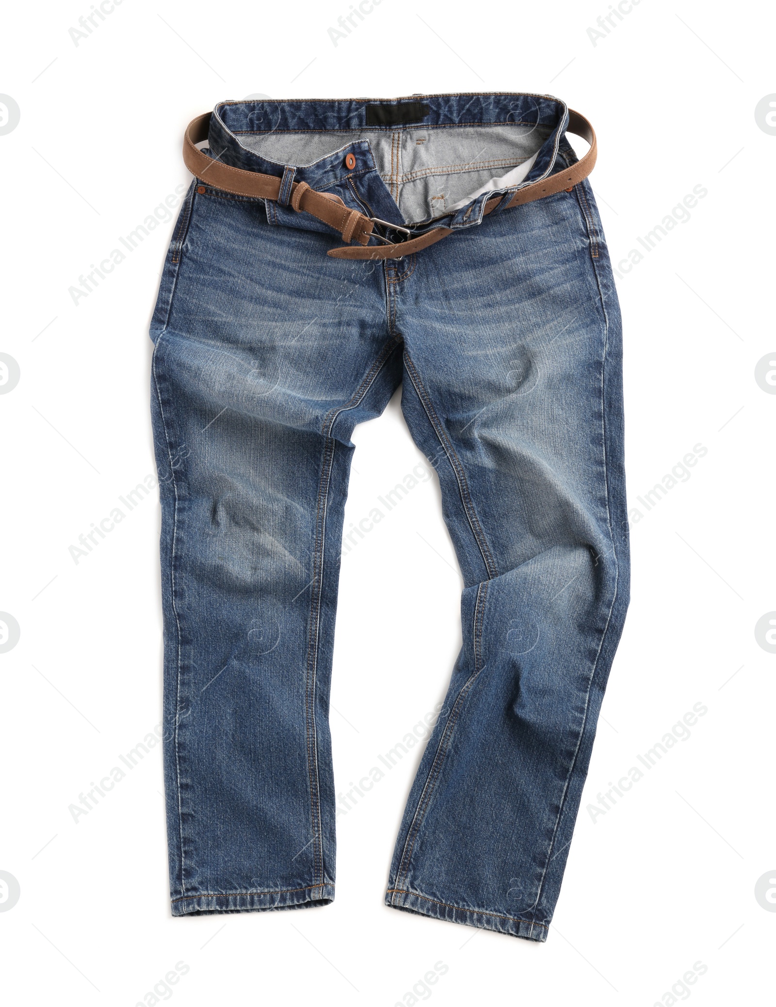 Photo of Rumpled blue jeans with belt isolated on white, top view. Stylish clothes