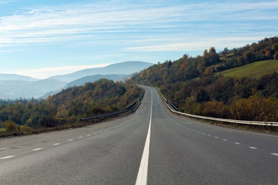 Photo of Landscape with asphalt road leading to mountains