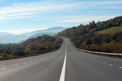 Landscape with asphalt road leading to mountains