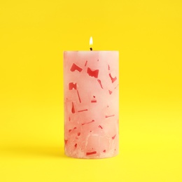 Alight scented wax candle on color background