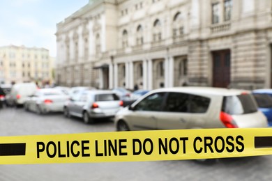 Image of Yellow crime scene tape blocking way on street