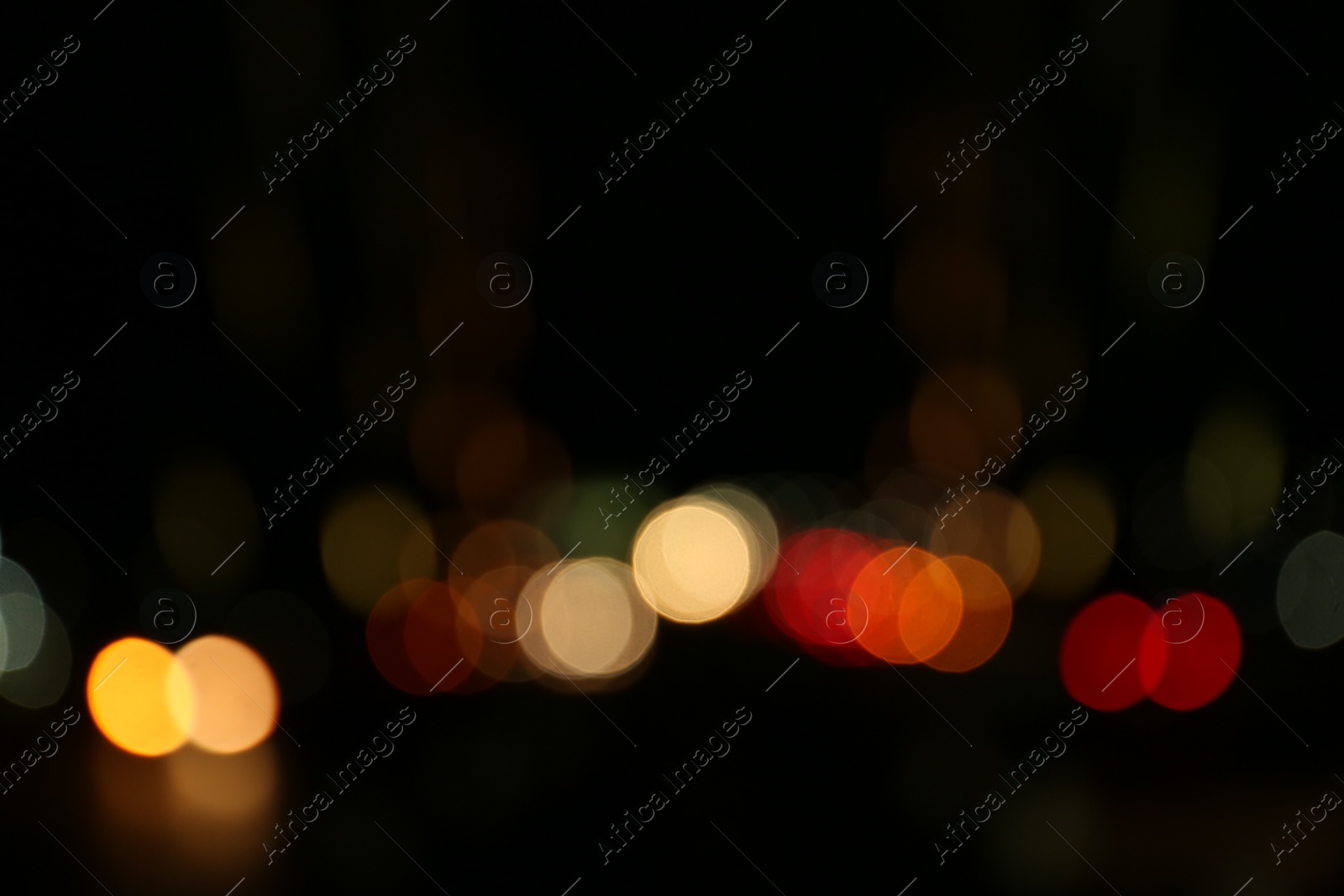 Photo of Blurred view of city lights at night. Bokeh effect