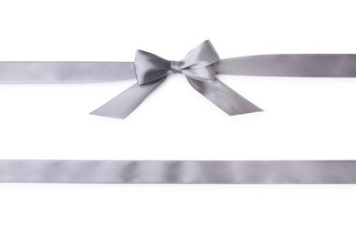 Grey satin ribbons with bow on white background, top view