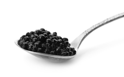 Metal spoon with black caviar on white background