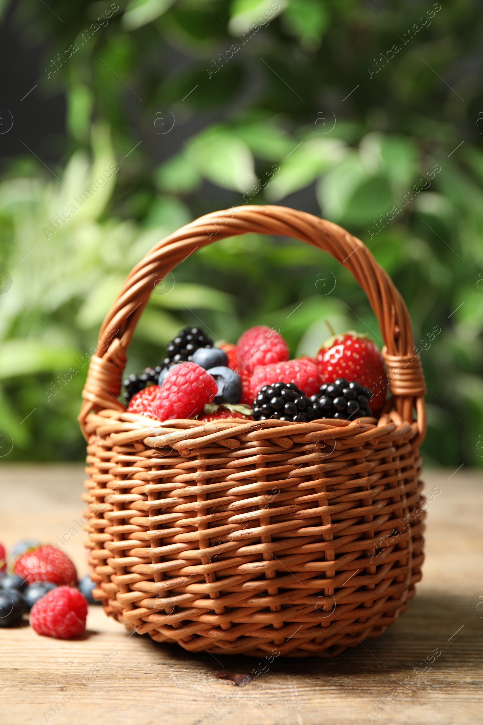 Photo of Mix of ripe berries on wooden table