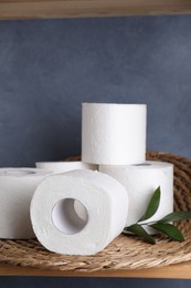 Photo of Toilet paper rolls and green leaves on shelf